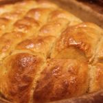 A pan of scored herby pull-apart bread fresh from the oven