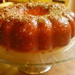 Rum cake with glaze and nuts on a pedestal stand