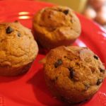 Red plate containing chocolate chip pumpkin muffins
