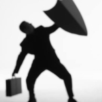 Silhouette of a man with a briefcase in one hand and an upheld shield in the other