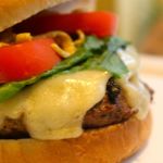 Side view of a turkey burger with cheese melting down the side