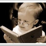 child wearing glasses reading a book