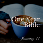 Open Bible on table with mug of coffee in foreground.