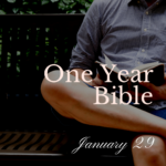 Man on bench reading Bible