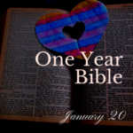 A blue and red paper heart laid on top of an open Bible