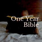 Just the top of the head of a small child peeking above the Bible he or she is reading. The child is under a comforter.