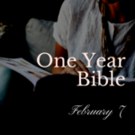 Person in white shirt holding an open Bible
