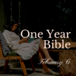 Girl in white dress sitting on a chair outside reading a Bible