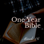 An open Bible in the lap of a man wearing a blue plaid shirt