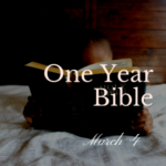 Child reading a Bible while under the covers
