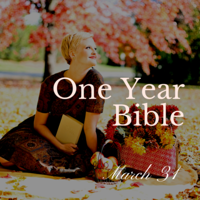 Smiling woman sitting on the lawn with an open Bible in her hand