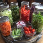 Six large mason jars full of vegetables