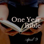 A man holding an open Bible in his lap