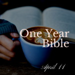 Woman wearing fingerless gloves holding a blue mug of coffee and reading a Bible