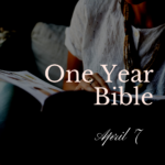 Person in a white shirt holding an open Bible in their lap