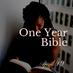 Woman sitting in front of a window reading a Bible
