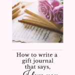 An open journal with pink roses sitting on top