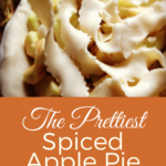 An unbaked spiced apple pie with twisted crust strips being arranged on top