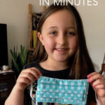 Girl holding up a teal face mask she made herself